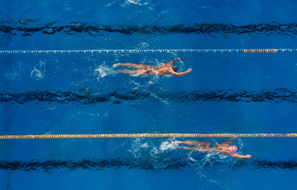 two swimmers training in an outdoor pool top view