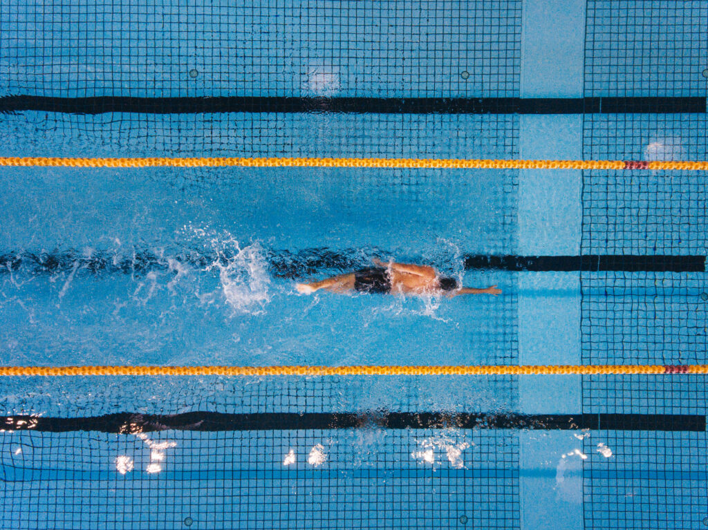 Young man swimming laps in a pool