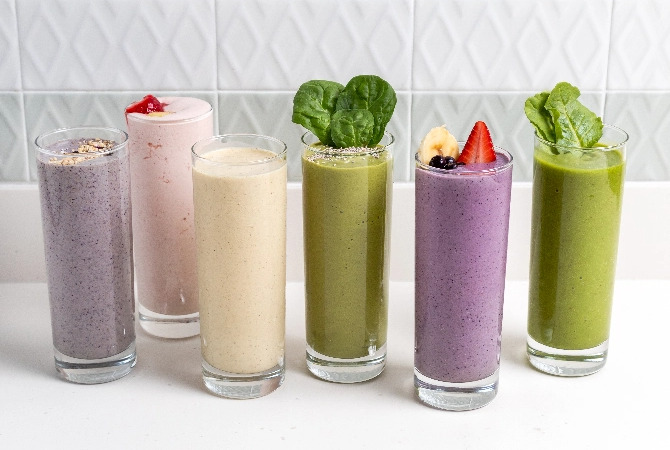 variety of fresh smoothies in glasses