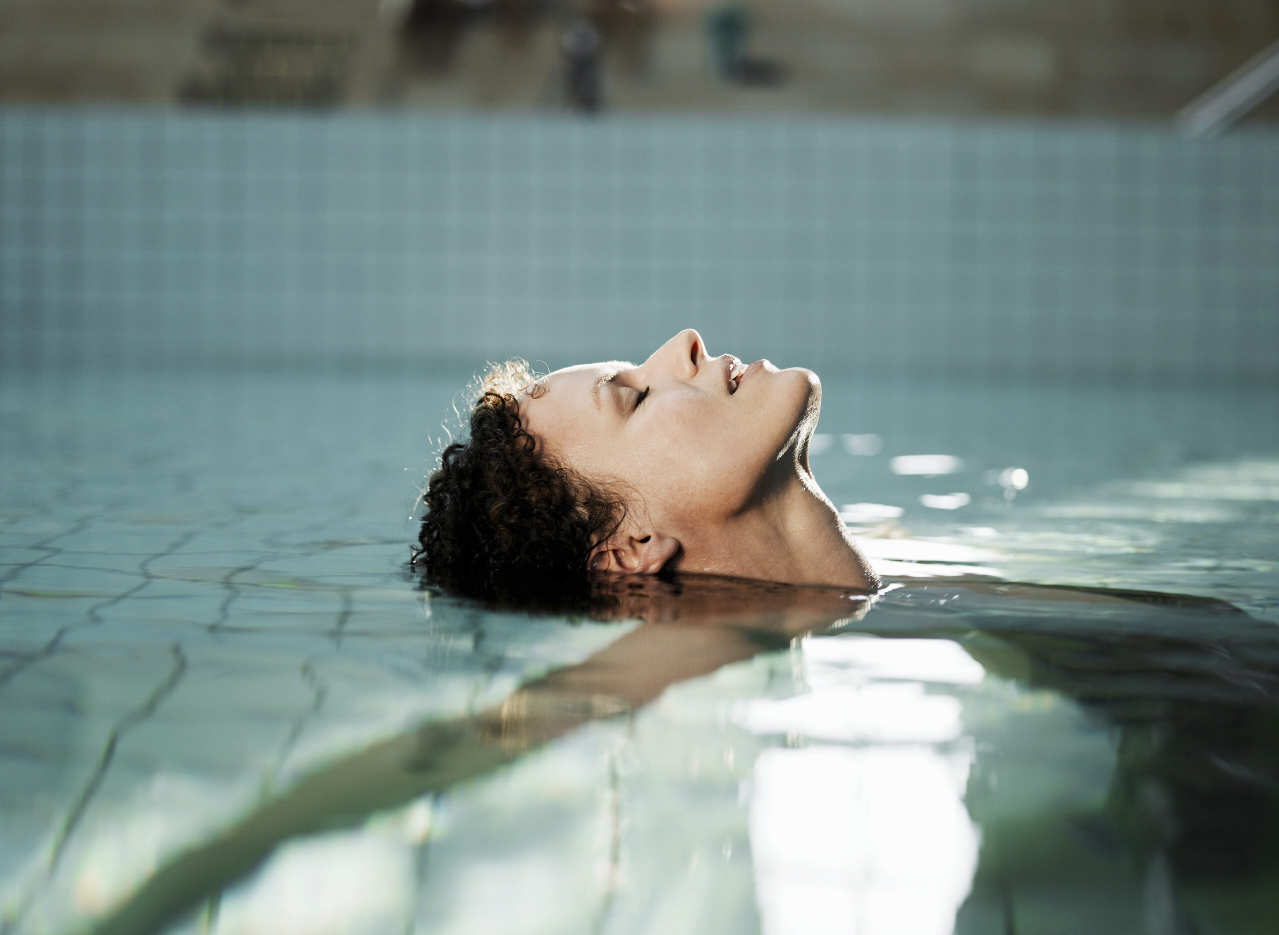 Woman lying in water side view