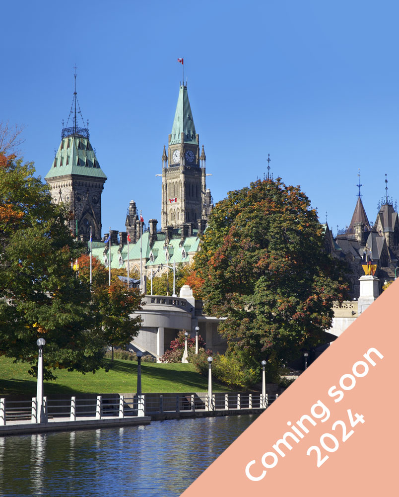 Photo of a view of the Parliament building in Ottawa viewing from the Rideau Canal